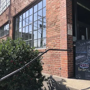 Located at front entrance of 1501 Preble Building by stairs or ramp