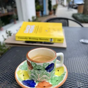 a cup of tea and a book on a table