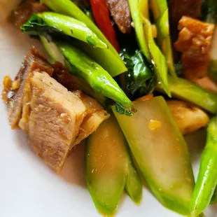 Raw broccoli with dried out and tough crispy pork