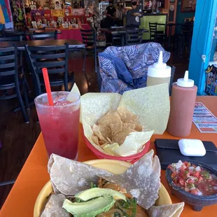Hibiscus margarita, chips and salsa, house verde and red salsa and the whole some bowl