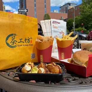 Takoyaki, spicy crispy chicken strips, French fries, crispy chicken burger, and classic milk tea