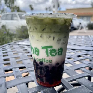Strawberry matcha oat milk latte with boba