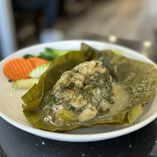 Mhok Pla: Steamed Catfish Fillet w/ dill, onion, garlic and herbs in banana leaf served w/ steamed veggies | $15