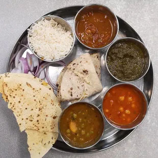 Thali - rice, kidney beans, saag (greens), garbanzo beans, potato &amp; peas, bread. Excluded dairy items to make it vegan