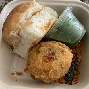 Mumbai Vada Pav boxed - fried potato cannonball, gunpowder below, the mint chutney neatly packed & the ubiquitous Bombay Pav!