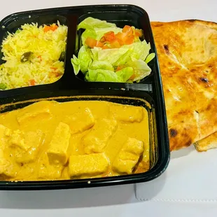 Catering lunch boxes served with nan rice dal salad