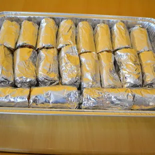Wraps andcKati rolls platter catering cut in half