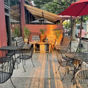 a patio with tables and chairs