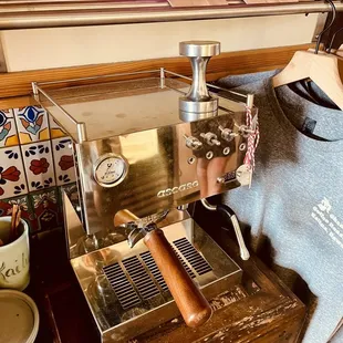 An espresso machine for sale along with coffee beans and other coffee making tools!