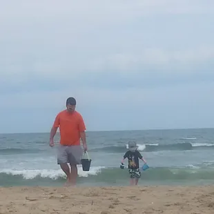a father and son playing on the beach