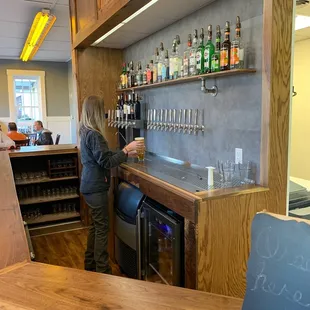 a woman standing at the bar