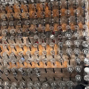a wall of beer glasses
