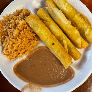 Rolled beef tacos with rice and beans