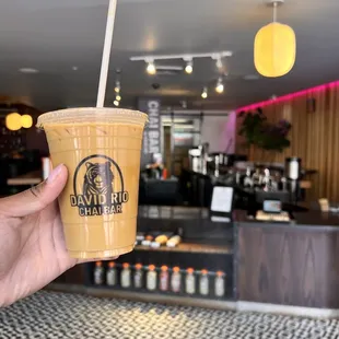 a hand holding a cup of coffee