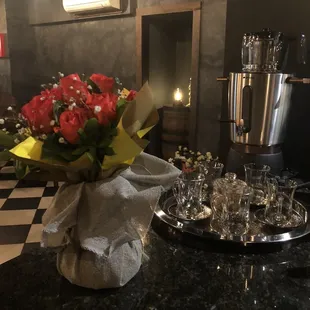 a bouquet of red roses in a glass vase