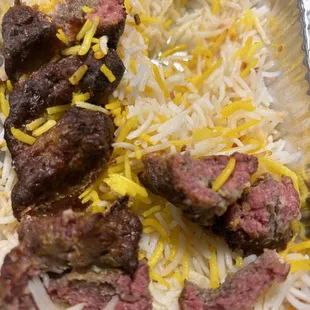 meat and rice in a tin foil container