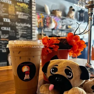 a cup of coffee and a stuffed animal