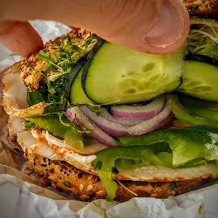 a sandwich with cucumbers and onions