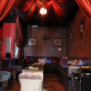 a living room with red drapes