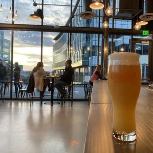 a glass of beer on a bar