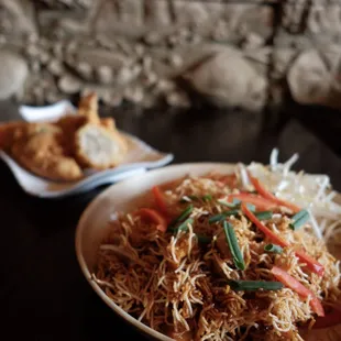 a plate of noodles and chicken