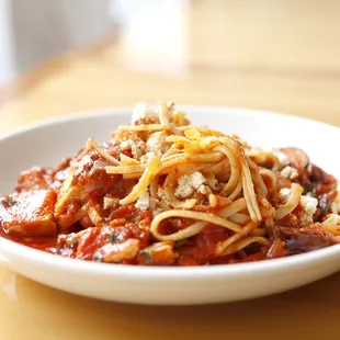 a bowl of spaghetti with meat and cheese