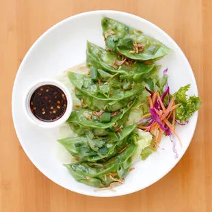 a plate of asian food with sauce