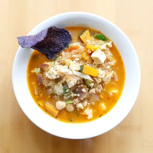 a bowl of soup and a tortilla