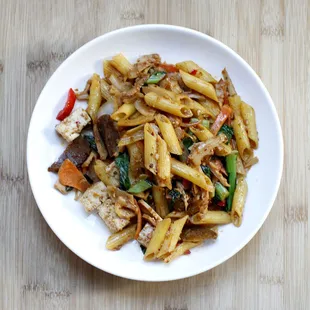 a plate of pasta with meat and vegetables