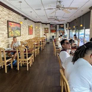 people sitting at tables in a restaurant