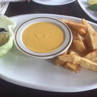 Fried Cassava (Yuca) with Huancaina Sauce / Yuca a la Huancaina