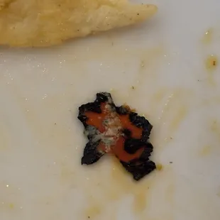 Found this inside my burrito!!  Not food. Halloween was yesterday...is it a melted Halloween thing?!!