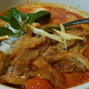 Red curry of duck with lychee apple eggplant okra lime leaf cherry tomato and thai basil