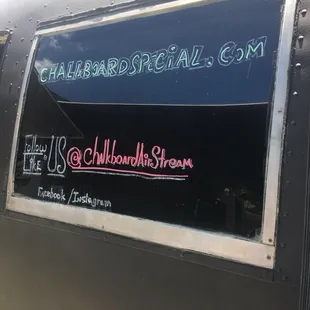 a sign on the side of a food truck