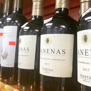 a row of wine bottles on a shelf