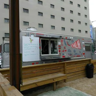 the food truck parked on the side of the road