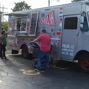 people standing around a food truck