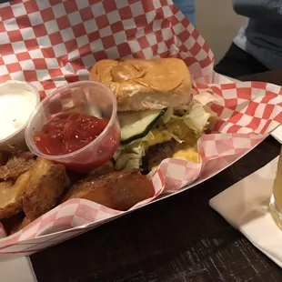Cheeseburger with a side of potato wedges.