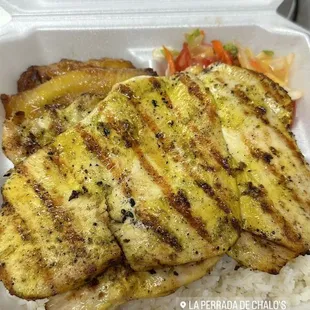 grilled chicken and rice in a styrofoam container