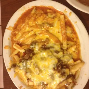 Cheesy fries enchilada style, half with green sauce and half with red.