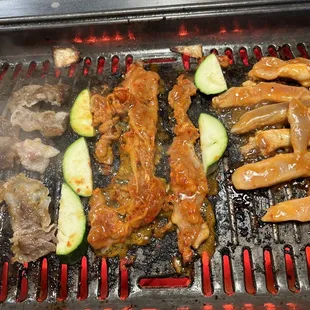 Meat, chicken and zucchini on the grill