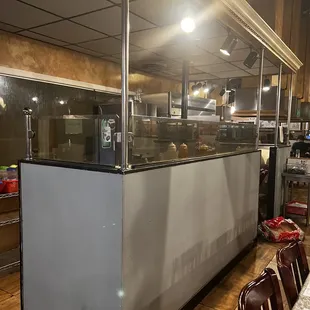 a restaurant with a counter and chairs