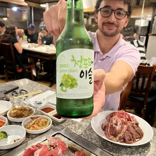 a man holding a bottle of beer