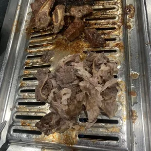 meat being cooked on a grill