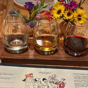 three glasses of wine and a menu