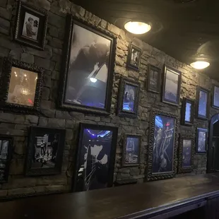  wall of framed photos and framed art