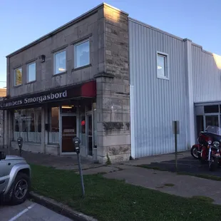 two motorcycles parked in front of a building