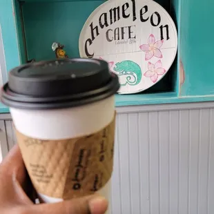 a hand holding a cup of coffee