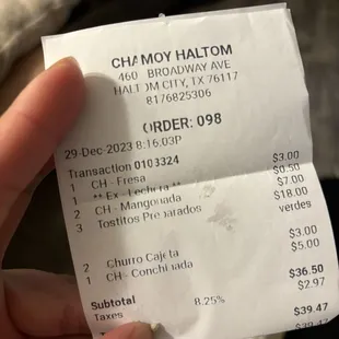 a person holding a receipt in their hand