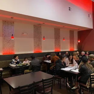 a large group of people eating in a restaurant